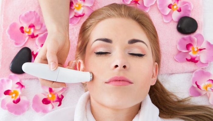 High Angle View Of Woman Getting Microdermabrasion Therapy In Spa